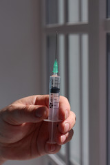 Doctor hold full syringe for injection medicine or vaccine.
