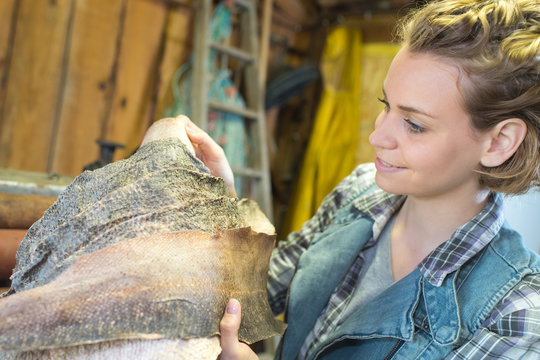female tailor checking leather