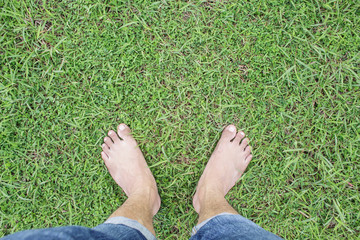 unique perspective barefoot relax on grass green background