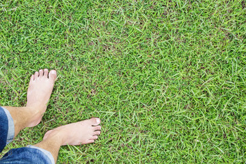 unique perspective barefoot relax on grass green background