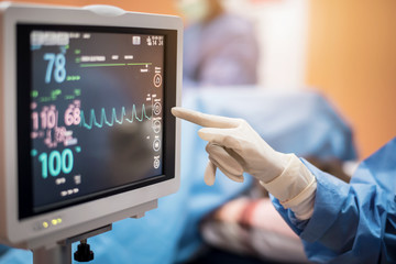 Electrocardiogram in hospital surgery operating  emergency room showing patient heart rate with...