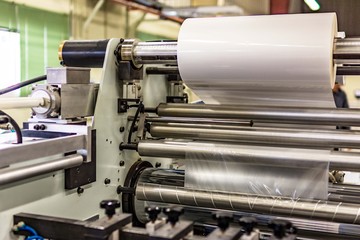 Matte or gloss plastic machine in a printing press for a perfect finish of printed documents.