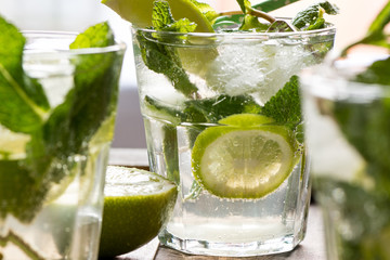 mojito cocktail with rum, lime and soda, garnished with mint