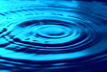 Naklejka na ściany i meble Blue water rippled texture. Abstract natural background. Water ripples.
