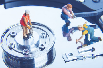 Technician workers repairing hard disk drive. Computer service concept.