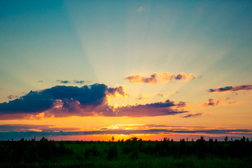 Summer sunset with sun rays
