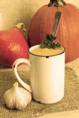 Pumpkin soup. Hot pumpkin soup with parsley and garlic. Close-up. Image in sepia colors.