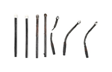 Black burned, extinguished matches isolated on white background, top view