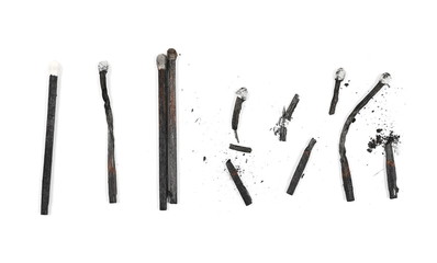 Black burned, extinguished matches isolated on white background, top view