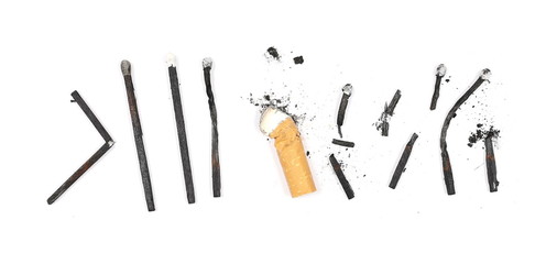 Black burned, extinguished matches and cigarette stub isolated on white background, top view