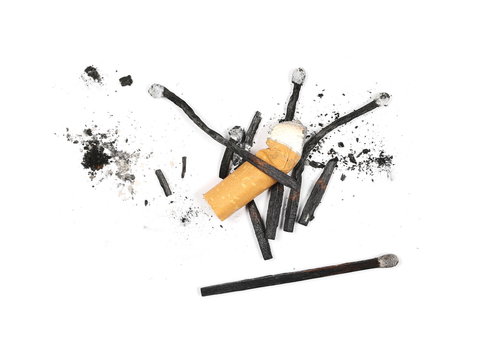Black burned, extinguished matches and cigarette stub isolated on white background, top view
