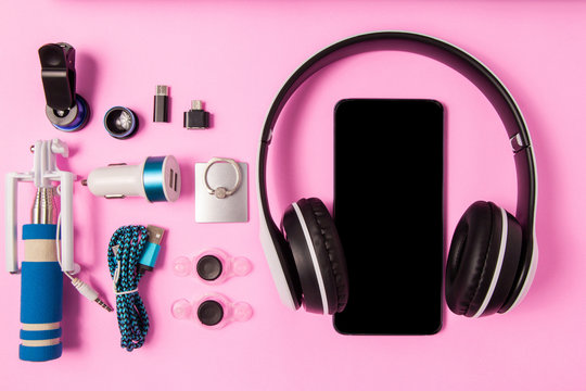 Headset listen music with mobile phone and Accessory set technology Blank space on bright pink background