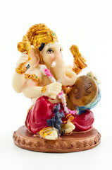 Gilded figure of the elephant Ganesha on white background