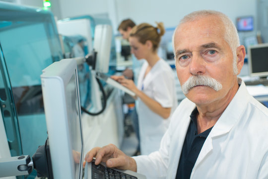 senior male researcher carrying out scientific research in a lab