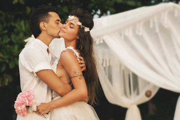 Beautiful married couple is celebrating their wedding on the beach