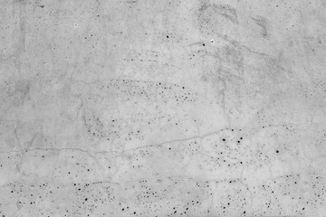 Old grunge grey wall with little holes.