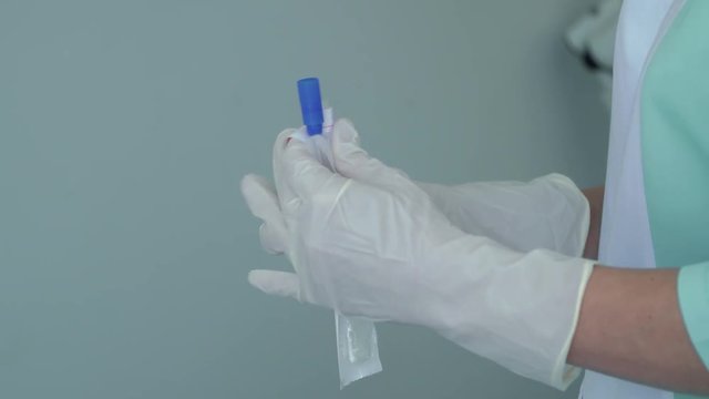 Doctor unpack sterilize q-tip for taking a swab
