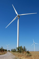 Windmills for electric power production. A wind turbine is a device that converts the wind's kinetic energy into electrical energy.