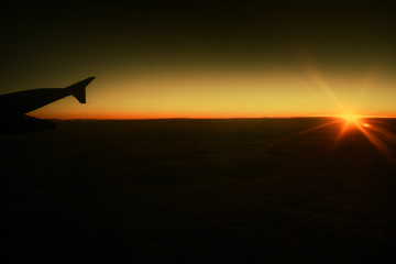 Airplane wing and beautiful  sunset.  Business trip. Commercial plane. Travel concept.