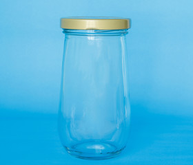 empty jar glass bottle on blue background