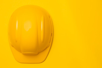 yellow construction helmet on a yellow background, head protection, concept, top view