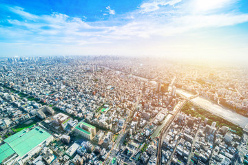 Asia Business concept for real estate and corporate construction - panoramic modern city urban skyline bird eye aerial view under sun & blue sky in Tokyo, Japan