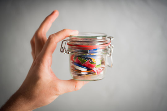 Zero waste concept - a man holding jar with trash