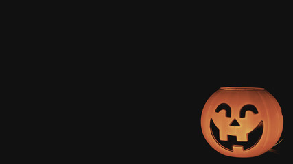 Halloween pumpkin illuminated with black background.