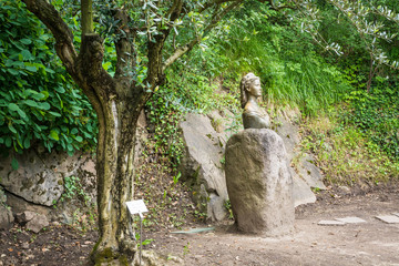 Fototapeta na wymiar Trauttmansdorff Garden in Meran (Merano), Italy: the statue of the empress sissi along the boulevard in the botanical gardens of Trauttmansdorff