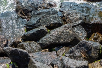 The surface of an old rock with cracks. Old rock texture (wild background).