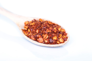 cayenne pepper spoon on white background