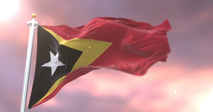 Flag of East Timor waving at wind at sunset in slow, loop