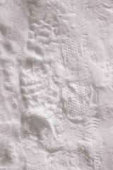 Fototapeta na wymiar Footprints of people's shoes in the snow