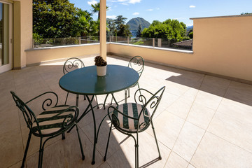 Spacious terrace of modern villa with lake view