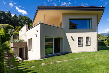 Villa with large garden during a summer day