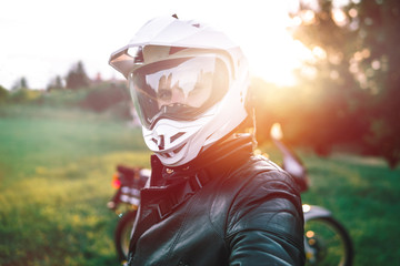close up portrait of Biker Man in white dual sport helmet, Adventure Motorcycle, off road travel concept, enduro rider equipment, extreme lifestyle, rady to ride - obrazy, fototapety, plakaty