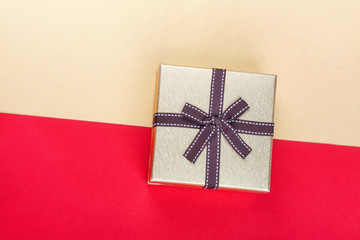 Golden gift box on red background.Top view flat lay group objects