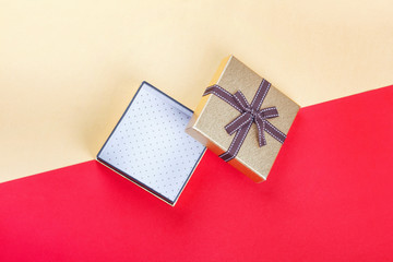 Golden gift box on red background.Top view flat lay group objects