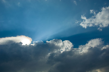 Sun lights and clouds in the sky - background