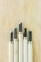 chisel carving set on wooden background