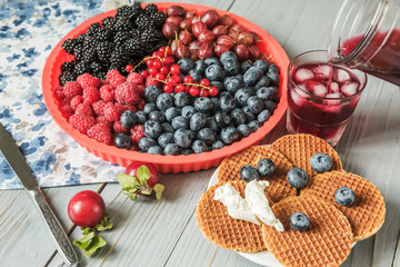 Different berries and wafers with cheese.
