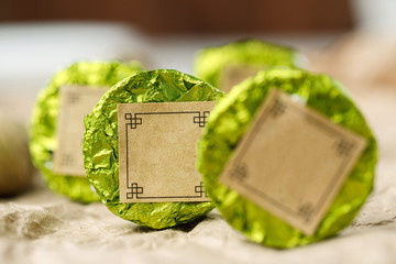 Chinese natural round shape tea packed in green aluminum foil, selective focus, macro