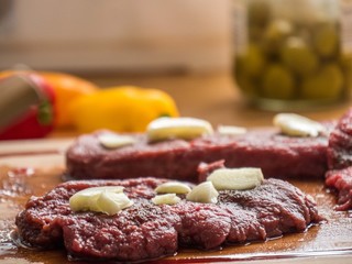 Raw beef stake on a wooden board