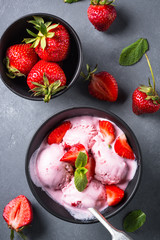 Strawberry ice cream on gray table. Top view. 