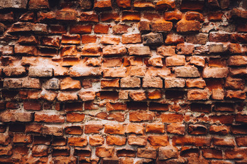 Old damaged wall made from red bricks.