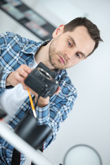 photographer cleaning digital camera