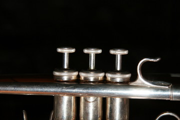 Fototapeta premium The trumpet valves on tha black background