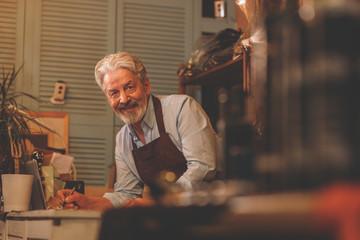 Smiling elderly man at work