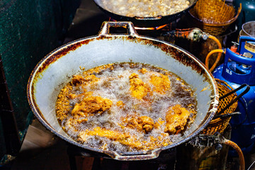 Chicken Deep Frying in Oil on Big Iron Pan Street Food.