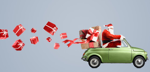 Santa Claus on car delivering Christmas or New Year gifts at gray background